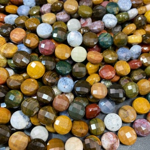 May include: A strand of round, faceted gemstone beads in various shades of brown, green, yellow, red, and white. The beads are approximately 10mm in diameter and have a polished, shiny finish.