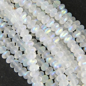 May include: A strand of iridescent white glass beads. The beads are round and have a frosted finish.