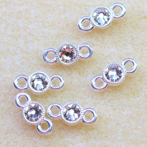 May include: Six silver-toned connector charms with clear rhinestone accents. Each charm has two loops for attaching to jewelry.