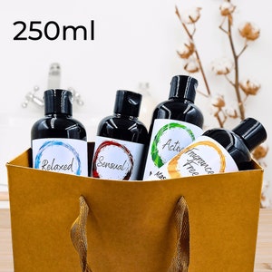 May include: Four 250 ml bottles of body wash in a brown paper bag. The bottles are labeled "Relaxed", "Sensual", "Active", and "Fragrance Free".