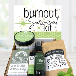 May include: A "Burnout Survival Kit" with a variety of self-care products. The kit includes a jar of body scrub, a bottle of refresh spray, a bar of lemongrass-mint soap, a lip balm, and a bag of bath salt soak. The kit is packaged in a cardboard box.