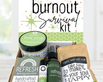 May include: A "Burnout Survival Kit" with a variety of self-care products. The kit includes a jar of body scrub, a bottle of refresh spray, a bar of lemongrass-mint soap, a lip balm, and a bag of bath salt soak. The kit is packaged in a cardboard box.
