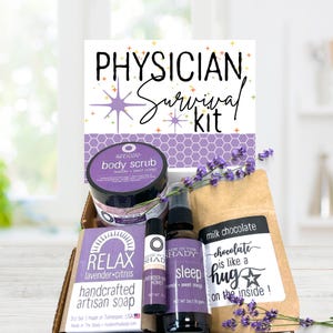 May include: A Physician Survival Kit gift box containing a body scrub, a lavender and citrus artisan soap bar, a lavender and honey lip balm, a sleep spray, and a milk chocolate bar. The items feature purple labels and sprigs of dried lavender.