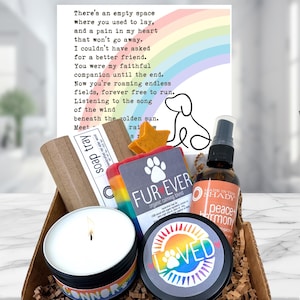 May include: A gift basket with a candle, soap, and spray bottle. The candle has a rainbow design and the word "Connor". The soap is labeled "Fur Ever". A card with a rainbow and dog outline is in the background.
