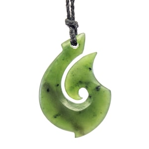 May include: A green jade Maori fish hook pendant on a black cord necklace. The hook is a traditional Maori symbol of good luck and prosperity.
