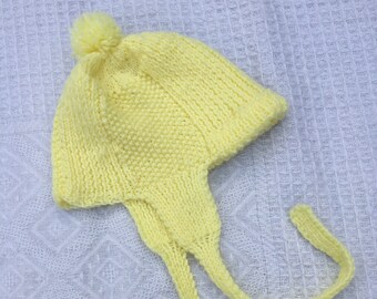 Vintage baby/toddler yellow knitted beanie with pom pom and ear flaps. Approx size 1.
