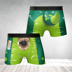 May include: Green and lime green underwear with a graphic design. One pair features a large, cartoonish tentacle, while the other has a graphic of an eye with a valve. The underwear has a black waistband.