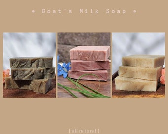 May include: Three bars of goat's milk soap, one is a light brown color, one is a light green color, and one is a light pink color. The soap is stacked on top of each other. The soap is all natural.