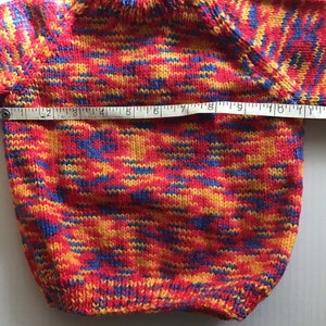 This jumper/sweater fits a 20 inch chest or a 9 month 18 month old. It is knitted in variegated yarn of red, blue and yellow. image 4