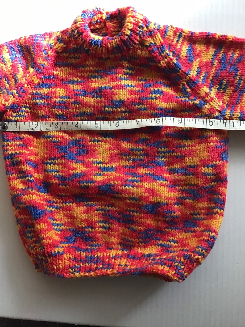 This jumper/sweater fits a 20 inch chest or a 9 month 18 month old. It is knitted in variegated yarn of red, blue and yellow. image 4