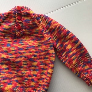 This jumper/sweater fits a 20 inch chest or a 9 month 18 month old. It is knitted in variegated yarn of red, blue and yellow. image 3