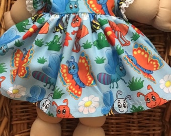 Fits a 14 inch Cabbage  Patch doll pretty blue mid length dress with Cartoon bugs, butterflies and bees and matching panties