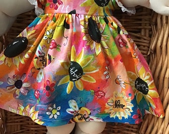 A colourful bees and sun flowers dress and matching panties to fit a 16 inch Cabbage Patch Doll.