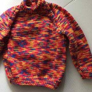 This jumper/sweater fits a 20 inch chest or a 9 month 18 month old. It is knitted in variegated yarn of red, blue and yellow. image 2