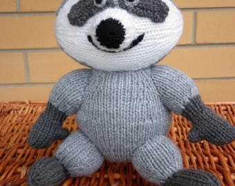 handknitted raccoon designed by Alan Dart and he is ready to ship.