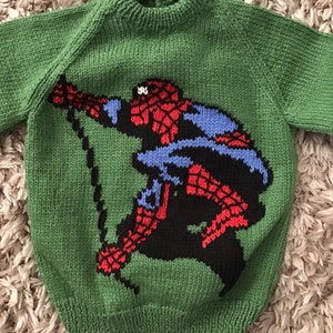 This sweater fits a 22 inch chest or a 1-2 year old approximately and has Spiderman embroidered on the front and is knitted in green