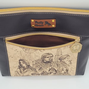 May include: A black leather purse with a gold zipper and a brown fabric lining. The purse has a pocket on the front with a gold zipper and a gold charm. The pocket features a printed design of a city scene with people and buildings.