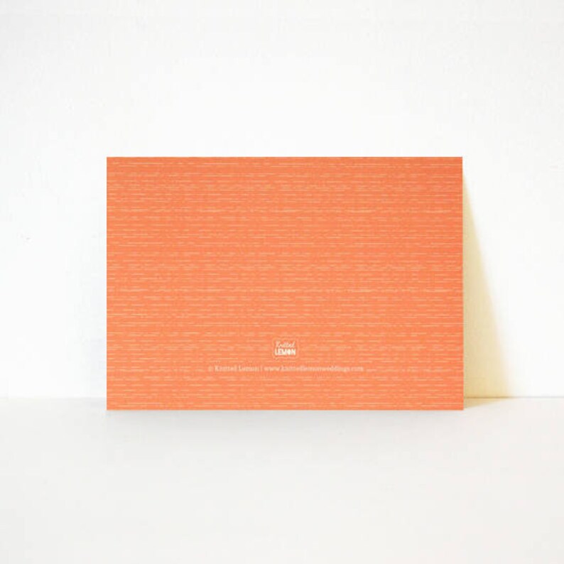 May include: A blank orange card with a white logo that says "Knitted Lemon" and a website address.