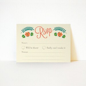 May include: A light beige RSVP card with a floral design in shades of green, orange, and white. The text "RSVP" is written in red cursive. The card has two options for guests to choose from: "Will be there!" or "Sadly can't make it".