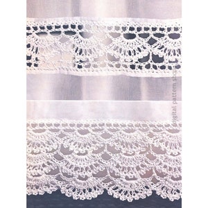 May include: White crochet lace trim with a scalloped edge. The lace is delicate and intricate, with a repeating pattern of small flowers and leaves.