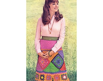 Peut inclure: Une jupe en crochet colorée avec un motif géométrique. La jupe est composée de carrés de différentes couleurs, notamment rose, orange, vert, violet et jaune. La jupe est portée par une femme aux longs cheveux bruns et une chemise rose.