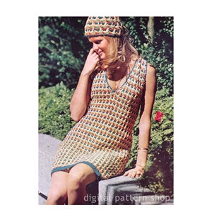 May include: A crochet dress with a geometric pattern in shades of yellow, orange, blue, and green. The dress has a V-neckline and sleeveless design. The model is wearing a matching crochet hat.