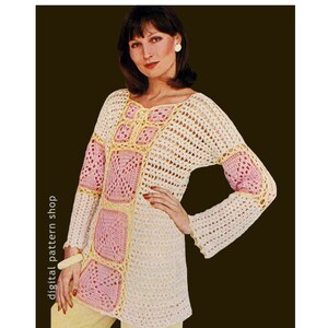 May include: A crocheted top with a square pattern in pink and yellow. The top has long sleeves and a loose fit.