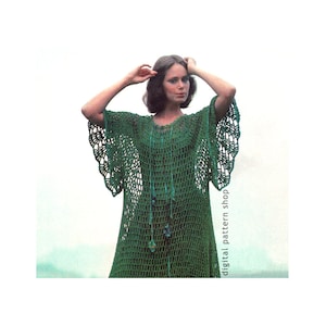 May include: A green crochet dress with a scalloped hem and bell sleeves. The dress is made of a lightweight, open-weave fabric and has a relaxed fit. The model is wearing a necklace with green and blue beads.