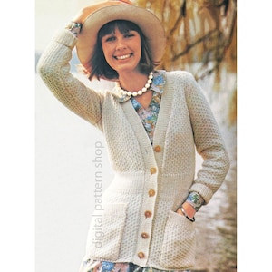 May include: A woman wearing a beige cardigan with a textured knit pattern, button closures, and pockets. She is also wearing a floral print blouse, a pearl necklace, and a wide-brimmed hat. The image has the text "digital pattern shop".