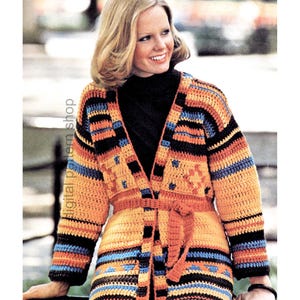 May include: A vibrant, long-sleeved crochet cardigan in orange, black, blue, and brown. The cardigan has a belt and a geometric design. The text "digital pattern shop" is visible on the left side.