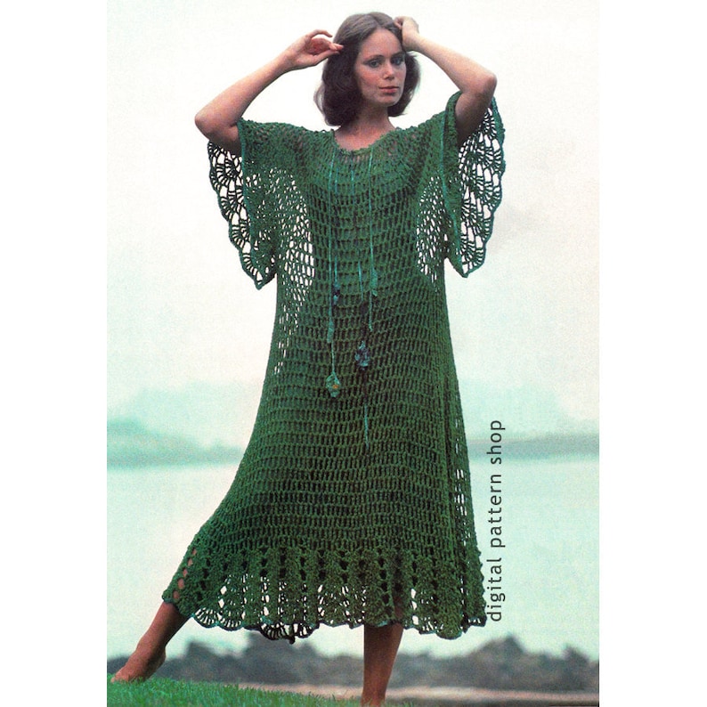 May include: Green crochet maxi dress with a scalloped hem and bell sleeves. The dress is made with a simple stitch pattern and has a relaxed fit.