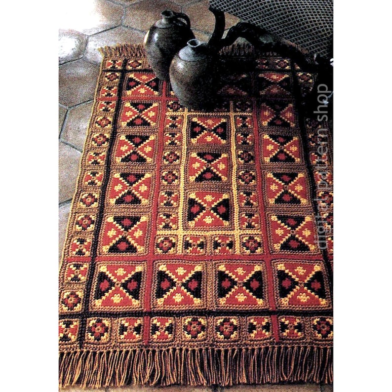 May include: A handmade crochet rug with a geometric pattern in red, black, and gold. The rug features a repeating square design with fringed edges. The rug is a warm, inviting home decor item.