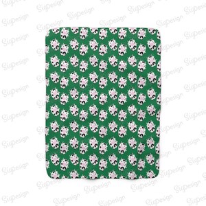 May include: A green fabric with a repeating pattern of white and black cows with pink noses. The cows are facing forward and have a simple, cartoon-like design.