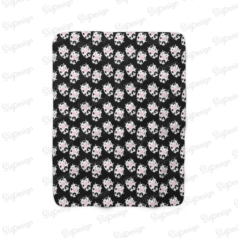 May include: Black and white fabric with a repeating pattern of pink and white cow faces.