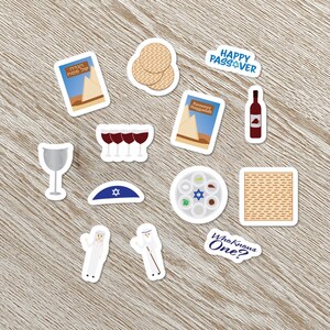 May include: A set of Passover stickers featuring a variety of traditional symbols, including matzah, wine, a Seder plate, and a kippah. The stickers also include the text "Happy Passover" and "Who Knows One?" in English.
