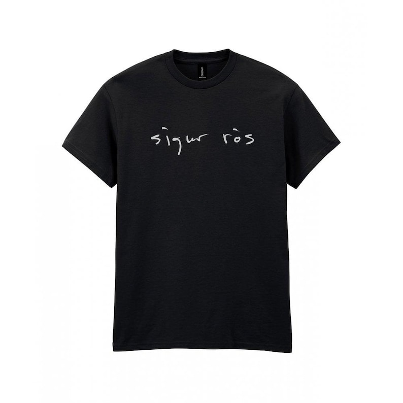 May include: Black t-shirt with the handwritten text "Sigur R&oacute;s" in white across the chest. The shirt has short sleeves and a crew neck.
