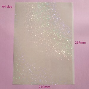 May include: A4 size sheet of paper with a glittery, iridescent finish. The sheet measures 8.3 inches wide by 11.7 inches tall. The glitter is scattered across the surface, creating a sparkling effect.