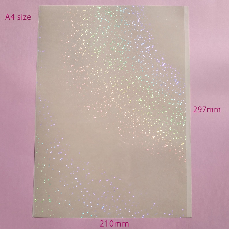 May include: A4 size sheet of paper with a glittery, iridescent finish. The sheet measures 8.3 inches wide by 11.7 inches tall. The glitter is scattered across the surface, creating a sparkling effect.