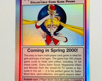 May include: A holographic card featuring Sailor Moon from the Sailor Moon Archive Collectible Card Game Promo. The card has a pink, blue, and purple holographic background with a picture of Sailor Moon holding her magic wand. The text on the card reads "Coming in Spring 2000!" and includes details about the card game.