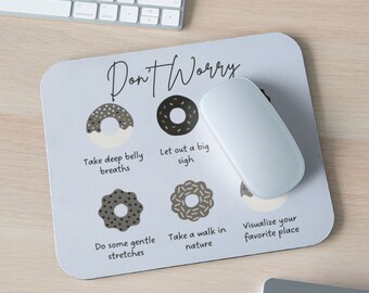 May include: A light blue mouse pad with the text "Don't Worry" in black script. The mouse pad features five donut illustrations with different toppings, each with a corresponding stress-relieving tip written below. The tips include "Take deep belly breaths", "Let out a big sigh", "Do some gentle stretches", "Take a walk in nature", and "Visualize your favorite place".