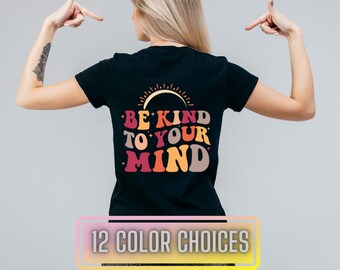 May include: Black t-shirt with a retro-style graphic that says "Be Kind To Your Mind" in rainbow colours with a sun graphic above the text.