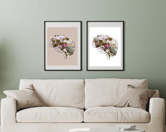 Puede incluir: Dos impresiones enmarcadas de un contorno de cerebro lleno de flores rosas y blancas. Las impresiones están en una pared blanca sobre un sofá blanco.