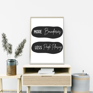May include: A black and white printable wall art print with the text "More Boundaries, Less People Pleasing" in a modern calligraphy font.