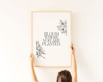 May include: A framed print with a black and white floral design and the text "Bloom where you are planted."