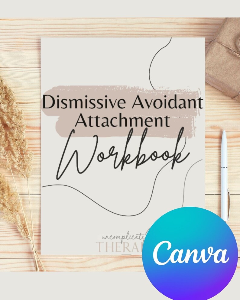 May include: A white and beige workbook with the text "Dismissive Avoidant Attachment Workbook" in black. The workbook is on a wooden surface with a brown paper bag and a pen.