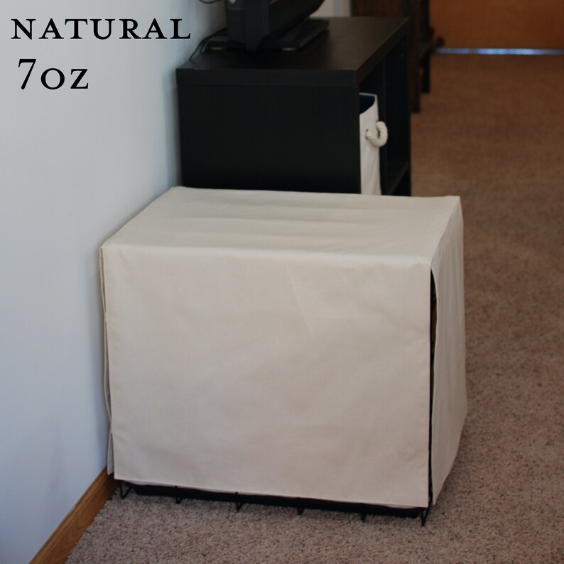 May include: A white canvas dog crate cover with the text "NATURAL 7OZ" on a white wall.