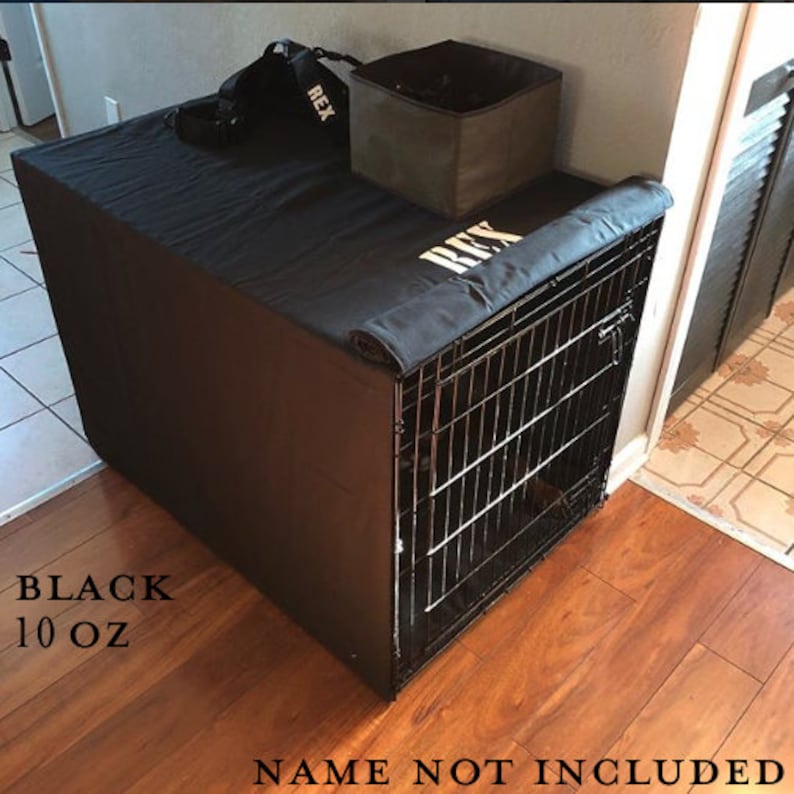 May include: Black dog crate cover with a black fabric flap and the name "REX" embroidered in white. The cover is made of 10 oz fabric.