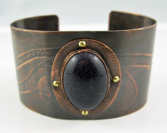 Riveted Blue Goldstone cuff bracelet in warm copper with textured dark brown and golden caramel patina