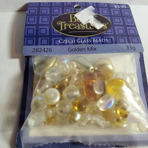 May include: A bag of Czech glass beads in a golden mix. The bag is labeled "Czech Glass Beads Golden Mix" and has the product number 282426. The bag also has a price tag of $3.99 and a weight of 33g.
