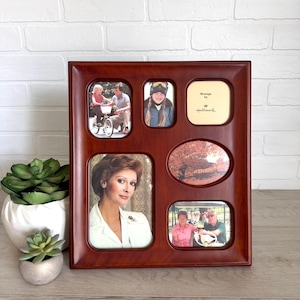 May include: A multi-photo wooden picture frame with a dark brown finish. The frame holds five photos of various sizes and shapes. One photo has the text "Message by Hallmark". The frame is displayed on a wooden surface.